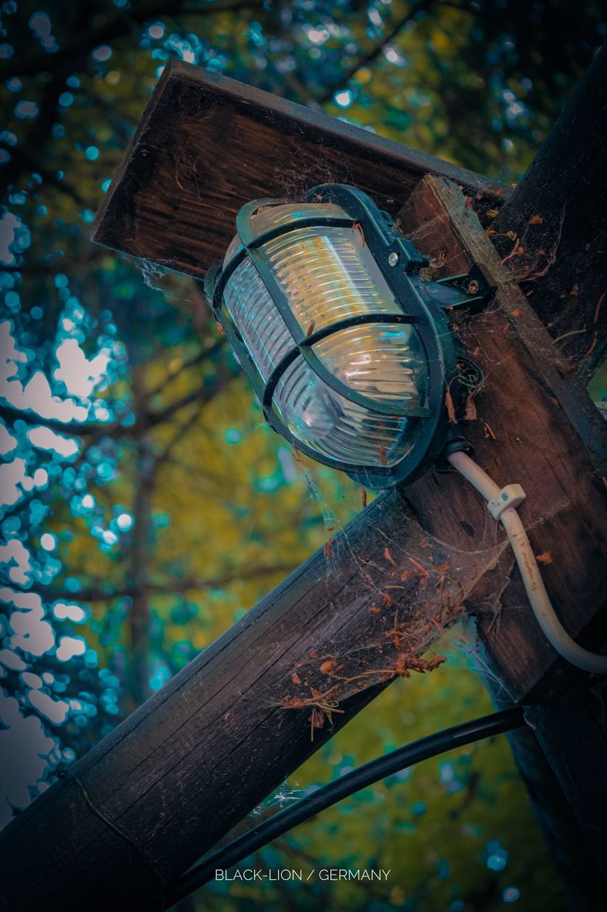 LOW ANGLE VIEW OF OLD ELECTRIC LAMP AGAINST BUILDING