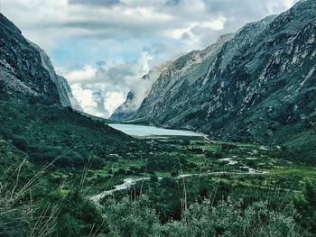 Scenic view of lake and mountains against sky