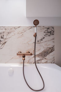 A bathtub with a shower head attached to it