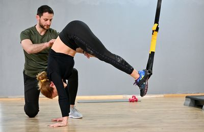 Full length of man and woman at the gym