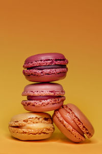 Close-up of macaroons against yellow background