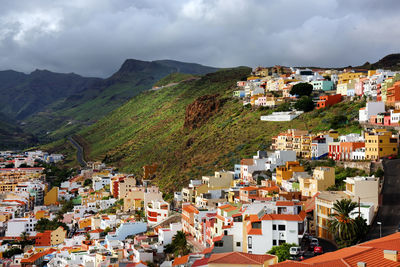 Residential district on mountain at san sebastian de la gomera against cloudy sky