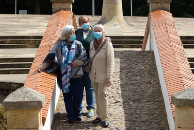 Rear view of people walking on staircase