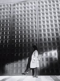 Woman standing against wall