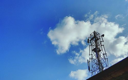 Low angle view of telephone pole against blue sky