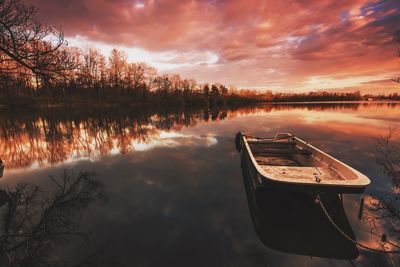 Scenic view of calm lake against cloudy sky