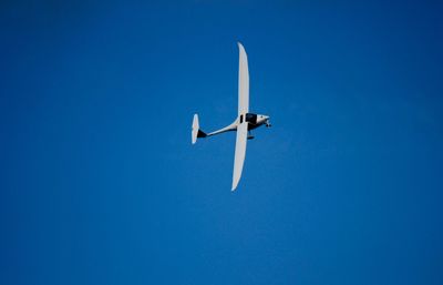 View of airplane against clear blue sky