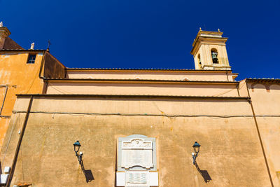 Low angle view of building against clear blue sky