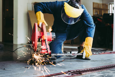 Man cutting metal in workshop