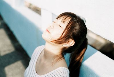 High angle view of woman relaxing on retaining wall