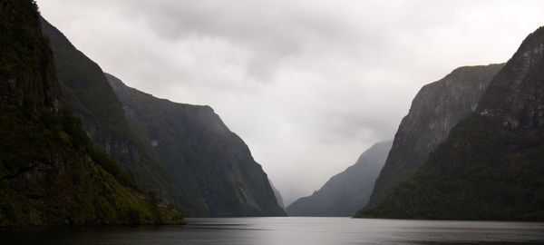 Scenic view of lake and mountains against sky