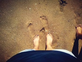 Low section of woman standing on beach