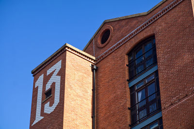 Low angle view of building against clear blue sky