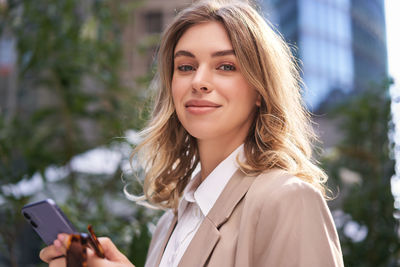 Portrait of young woman using mobile phone