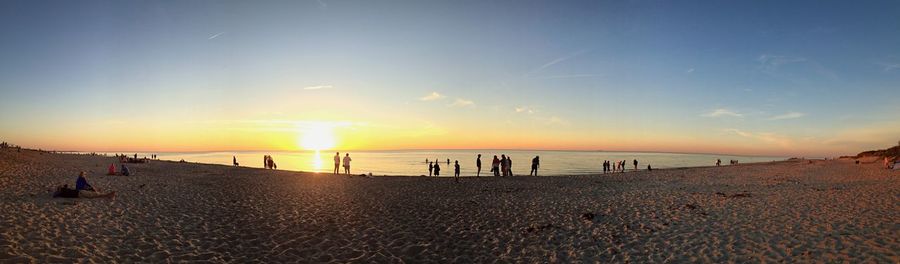 People on beach at sunset