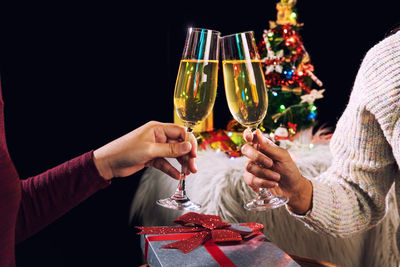 Cropped image of friends toasting champagne flutes