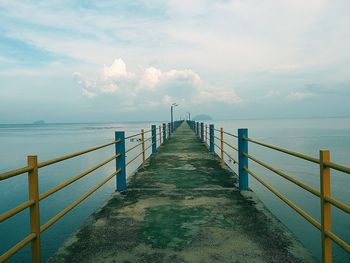 Pier over sea against sky