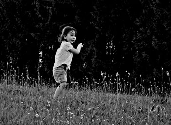 Portrait of girl lying on grassy field