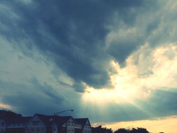 Low angle view of building against cloudy sky