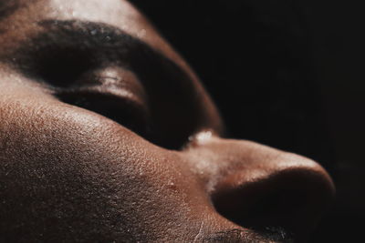 Close-up of man against black background