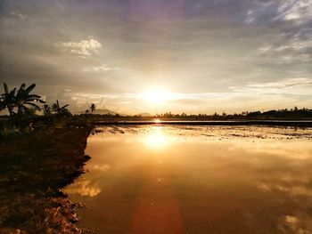 Scenic view of lake against sky during sunset
