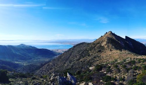 Scenic view of mountains against blue sky