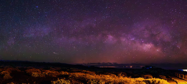 Scenic view of landscape against sky at night