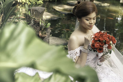 Bride with red roses bouquet