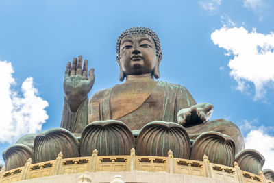 Low angle view of statue against cloudy sky