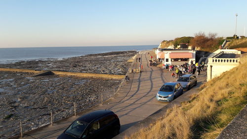 People on beach against clear sky