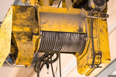 Close-up of yellow machine in factory
