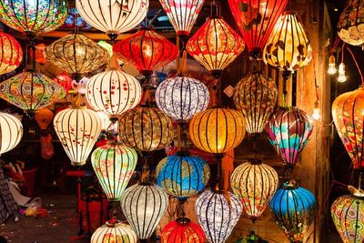 Illuminated lanterns hanging in row