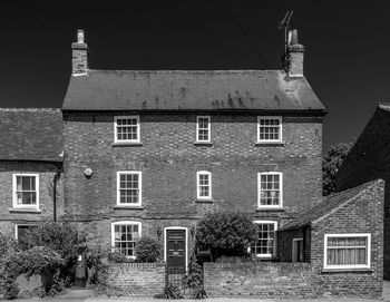 Houses in town against clear sky