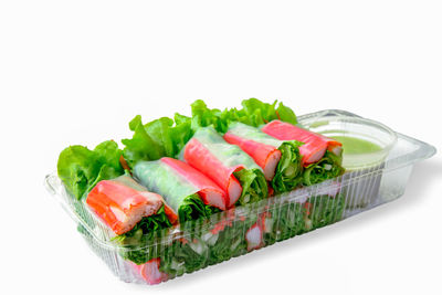 Close-up of salad in plate against white background