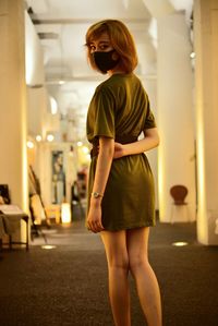 Full length of woman standing in corridor