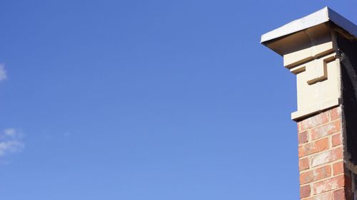 Low angle view of building against clear blue sky