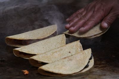 Cropped hand making tacos