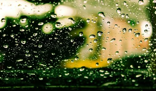 Close-up of wet glass window in rainy season