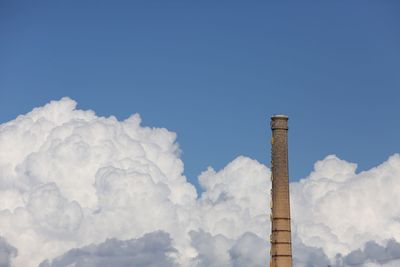 Low angle view of smoke stack against sky