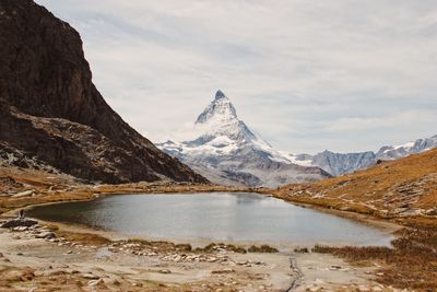 Scenic view of lake and mountains against sky