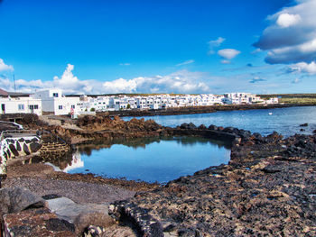 Scenic view of sea and buildings against sky