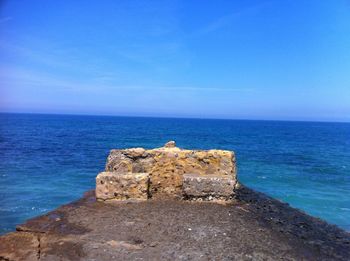 Scenic view of sea against blue sky