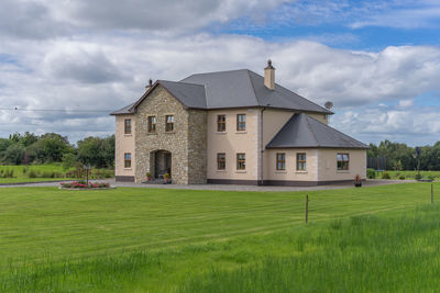 House on field against sky