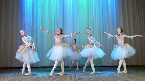 Ballet rehearsal, on the stage of the old theater hall. young ballerinas in elegant dresses 