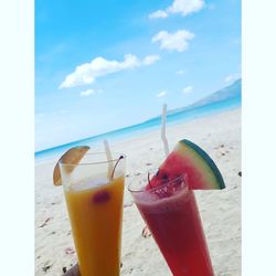 Close-up of drink on table at beach