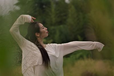 Portrait of young woman dancing outdoors