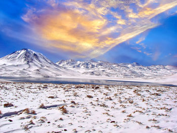 Scenic view of snowcapped mountains against sky during winter