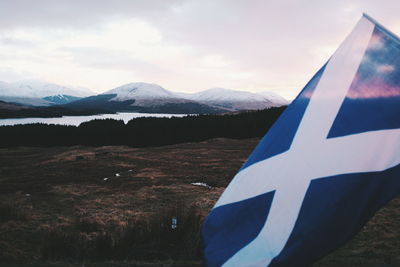 Scenic view of mountains against cloudy sky