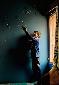 Boy playing with bubbles at home