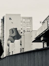 Low angle view of statue against building in city